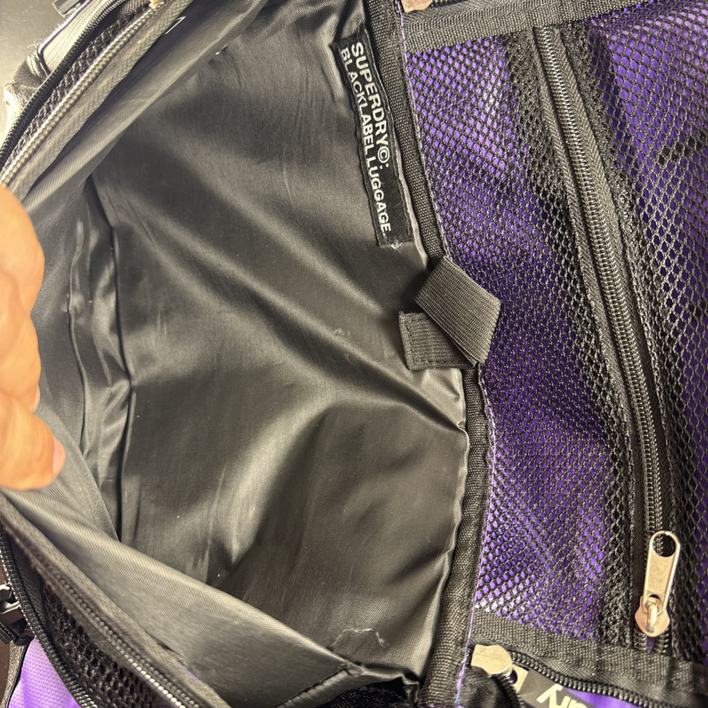 Purple and yellow Superdry tarp messenger bag with bold logo spellout and padded shoulder strap.