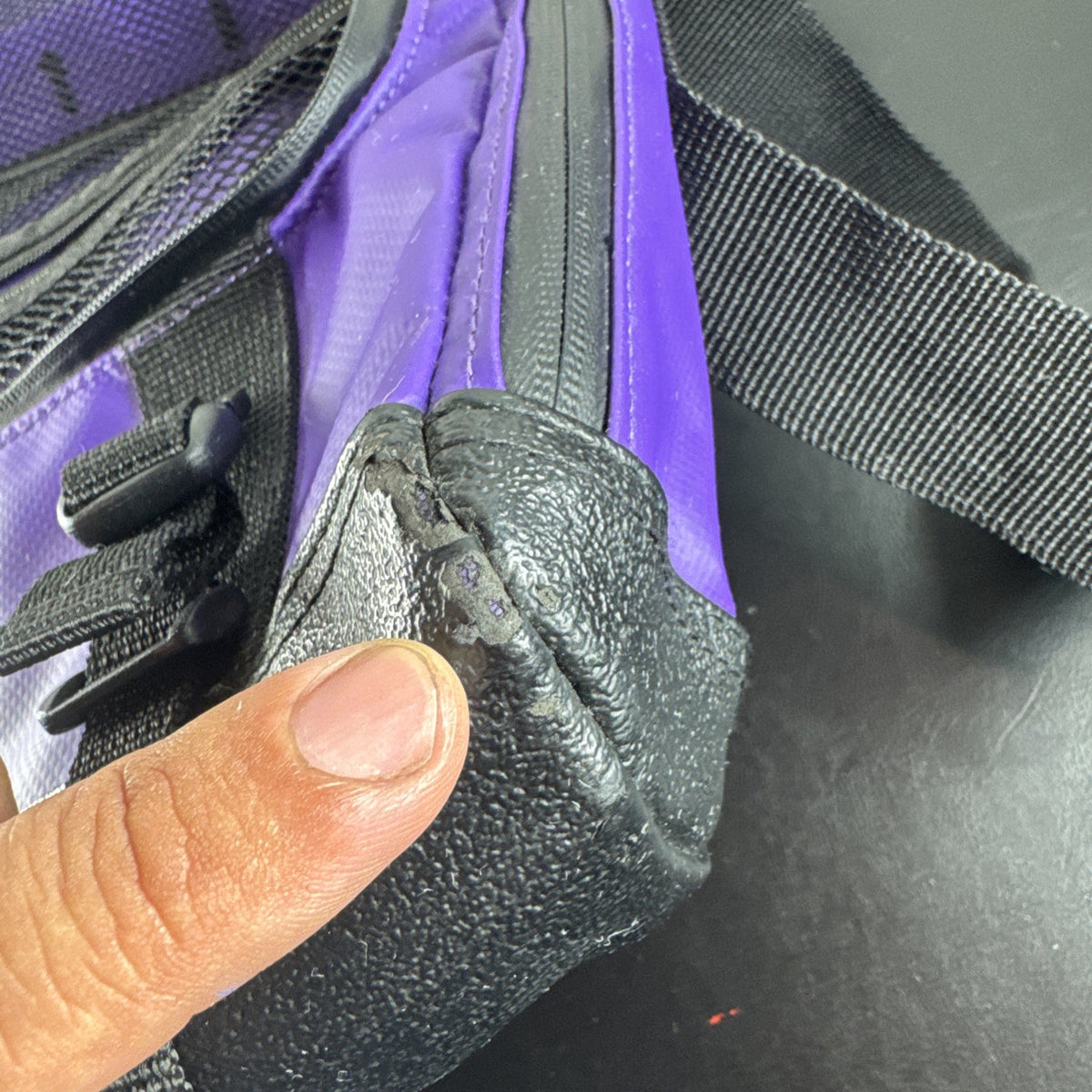 Purple and yellow Superdry tarp messenger bag with bold logo spellout and padded shoulder strap.