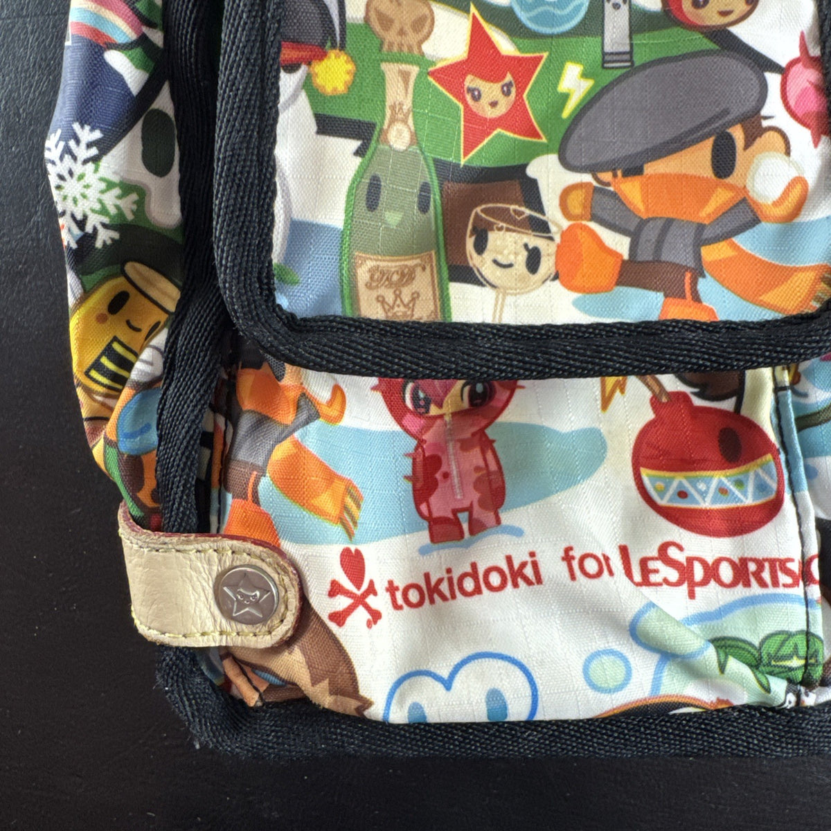 Tokidoki x LeSportsac Vacanze winter print crossbody messenger bag featuring colorful characters and front pockets
