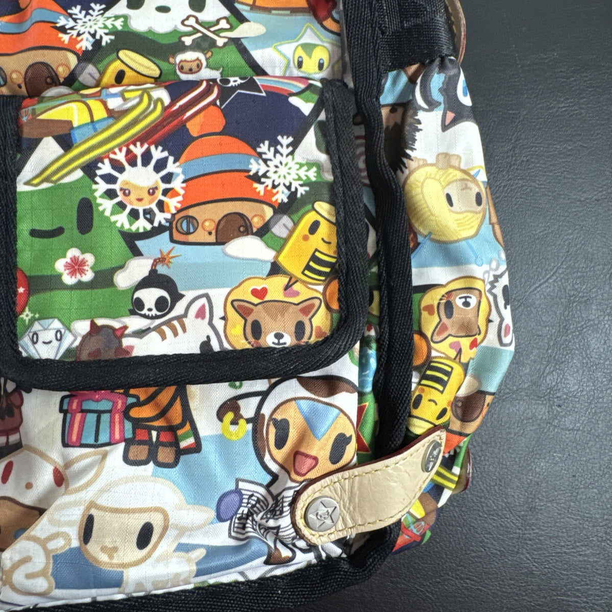 Tokidoki x LeSportsac Vacanze winter print crossbody messenger bag featuring colorful characters and front pockets
