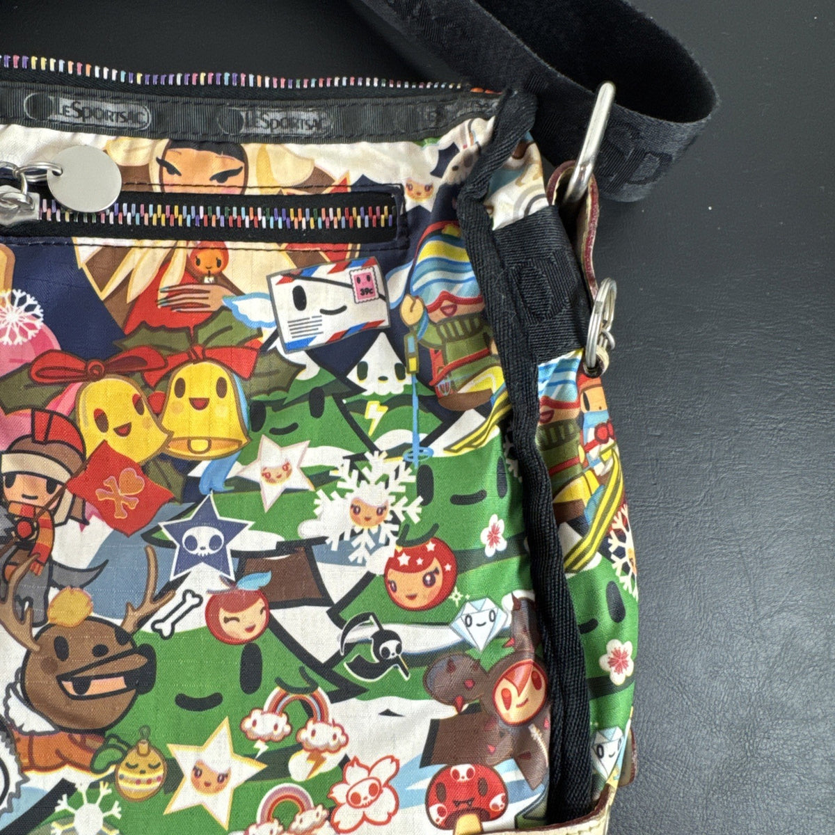 Tokidoki x LeSportsac Vacanze winter print crossbody messenger bag featuring colorful characters and front pockets
