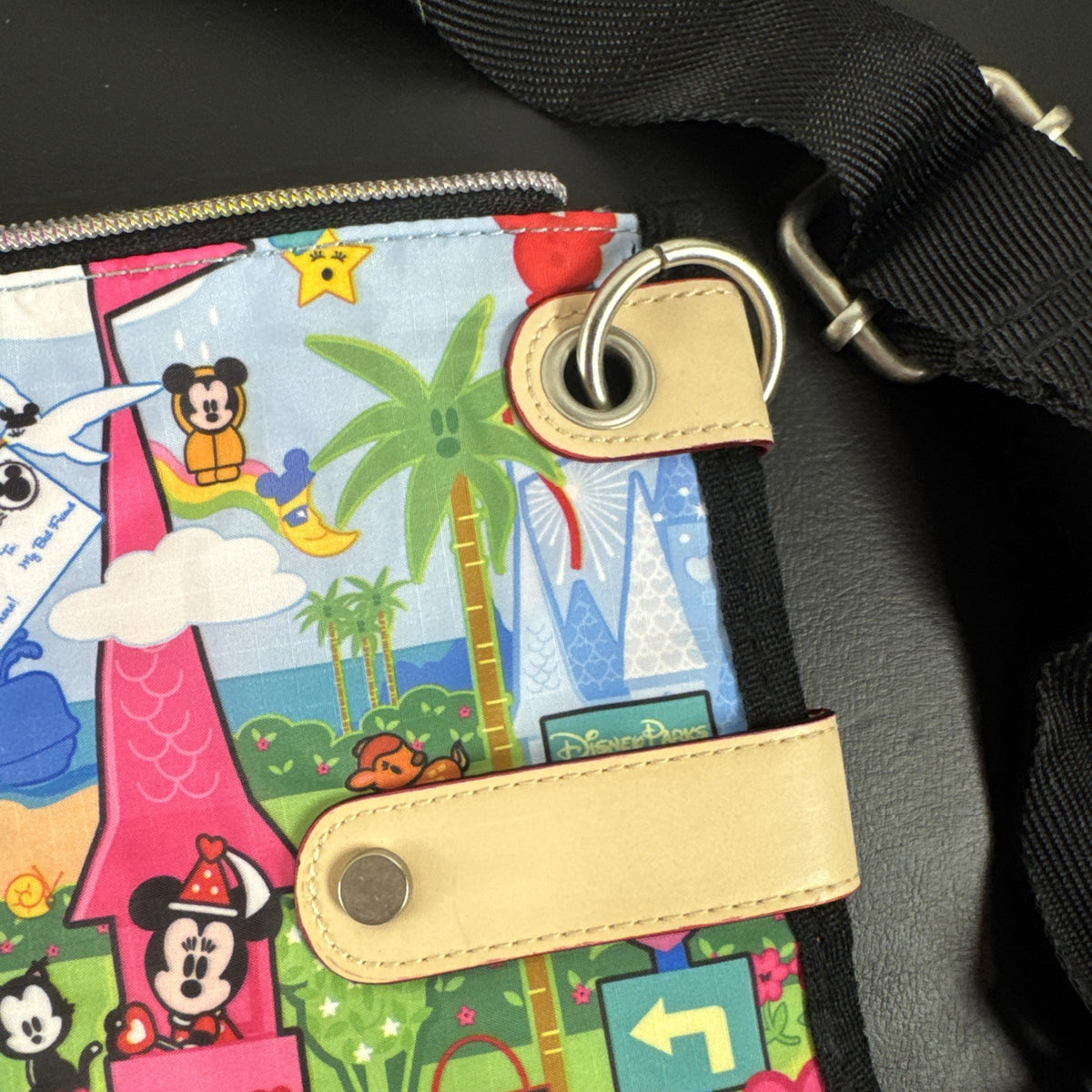 NWT Disney Parks convertible foldover crossbody tote bag in blue park map print with rainbow zipper front pocket.