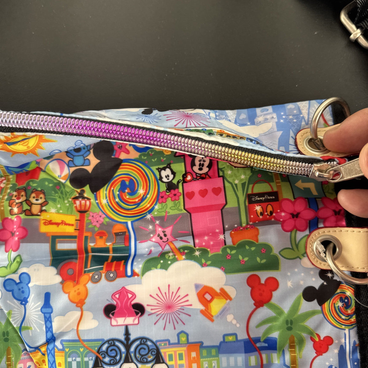 NWT Disney Parks convertible foldover crossbody tote bag in blue park map print with rainbow zipper front pocket.