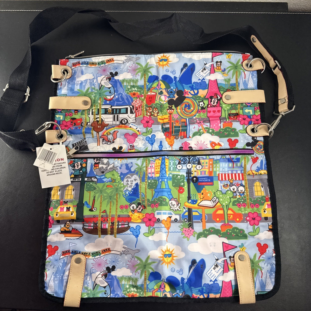 NWT Disney Parks convertible foldover crossbody tote bag in blue park map print with rainbow zipper front pocket.