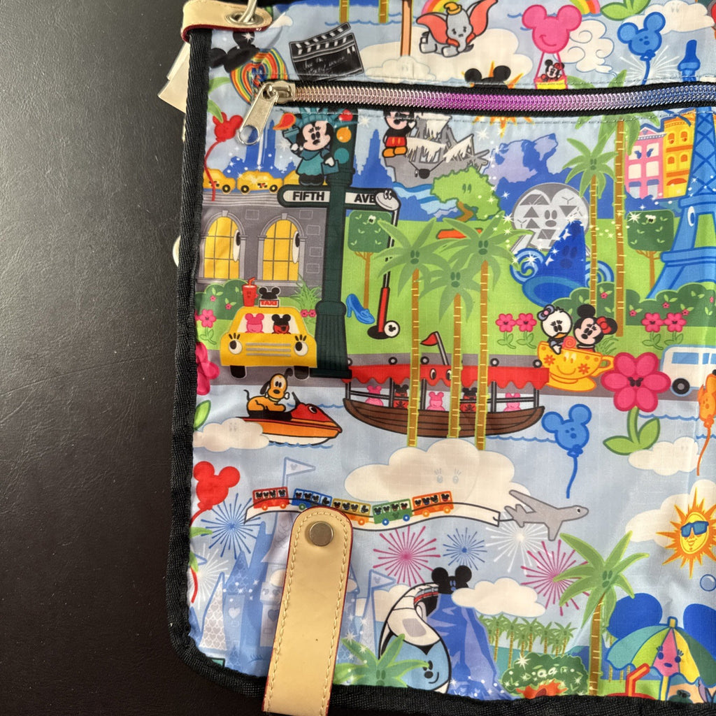 NWT Disney Parks convertible foldover crossbody tote bag in blue park map print with rainbow zipper front pocket.