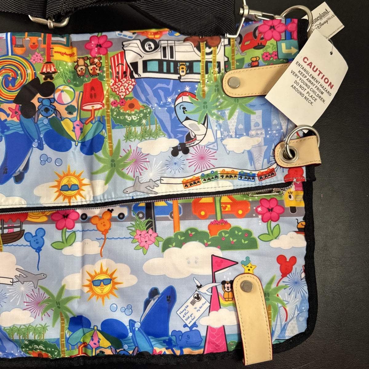 NWT Disney Parks convertible foldover crossbody tote bag in blue park map print with rainbow zipper front pocket.