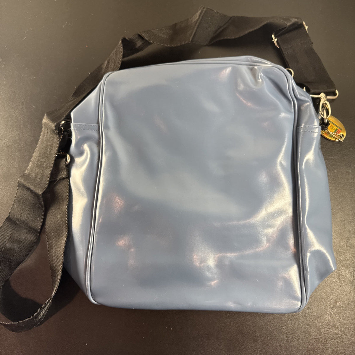 Disney 50th Anniversary retro map blue vinyl messenger bag featuring 1950s park graphics and Mickey ear charm.