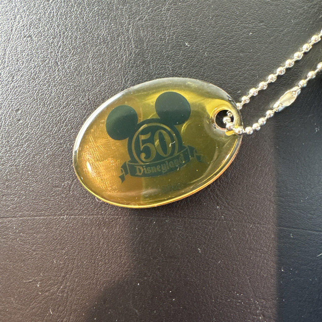 Disney 50th Anniversary retro map blue vinyl messenger bag featuring 1950s park graphics and Mickey ear charm.