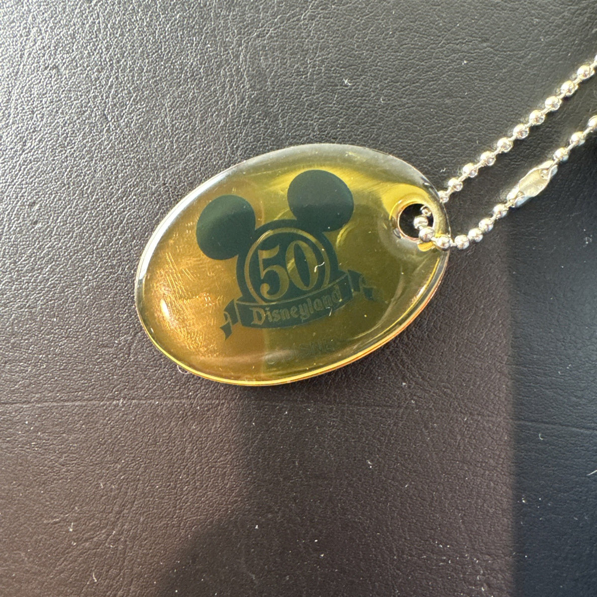 Disney 50th Anniversary retro map blue vinyl messenger bag featuring 1950s park graphics and Mickey ear charm.