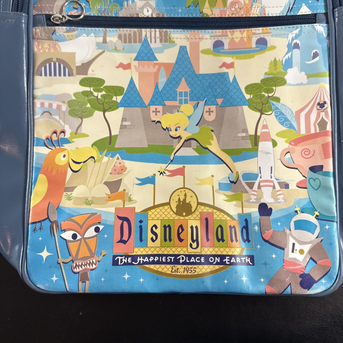 Disney 50th Anniversary retro map blue vinyl messenger bag featuring 1950s park graphics and Mickey ear charm.