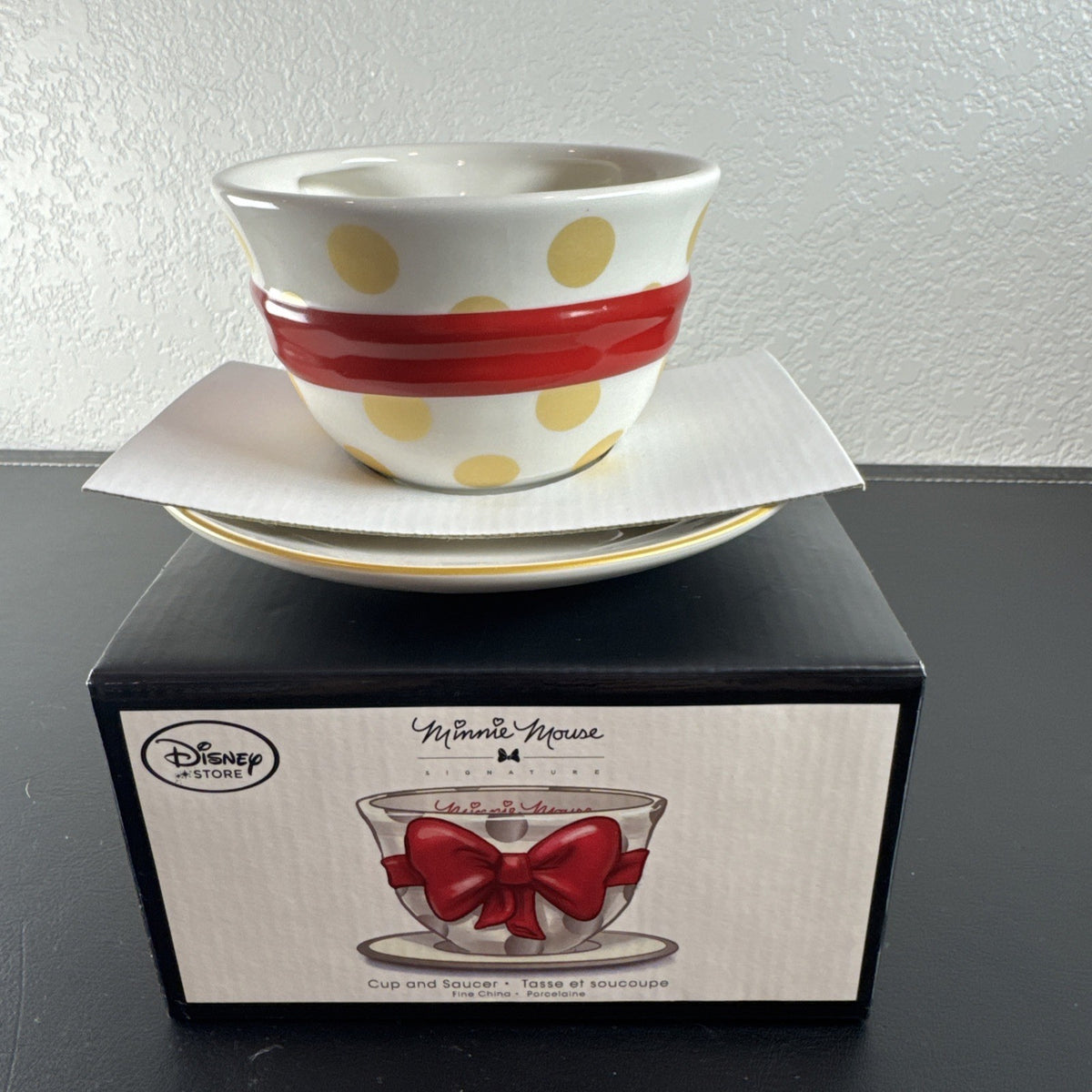 Disney Store Minnie Mouse Signature Collection cup and saucer set with red bow and polka dot design.