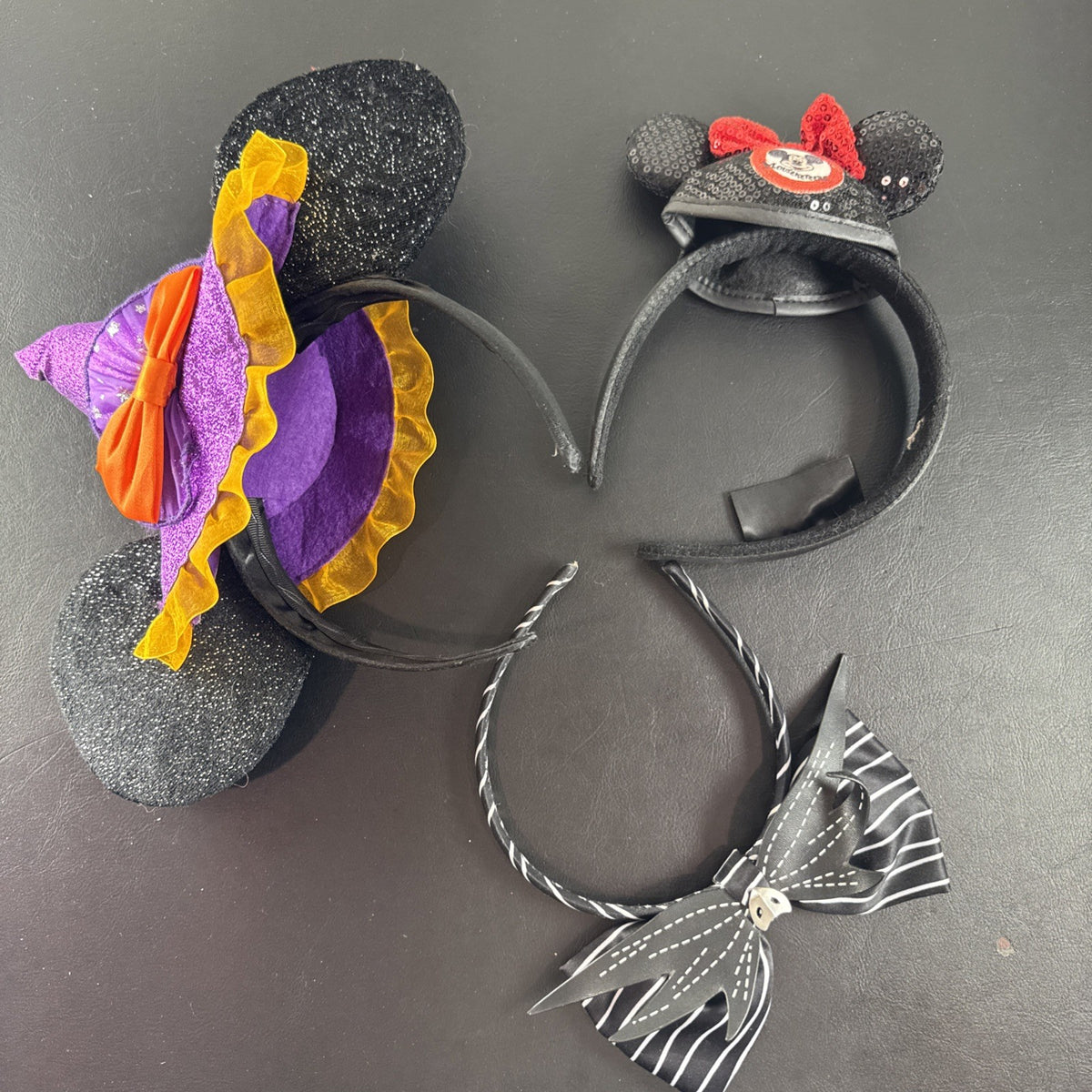 Lot of 3 Disney Parks Minnie Mouse ear headbands including Halloween Witch Hat, Mouseketeer, and Jack Skellington styles.