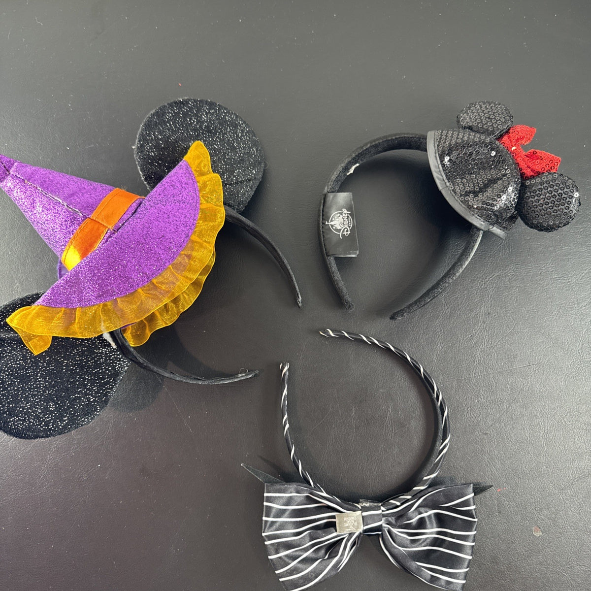 Lot of 3 Disney Parks Minnie Mouse ear headbands including Halloween Witch Hat, Mouseketeer, and Jack Skellington styles.