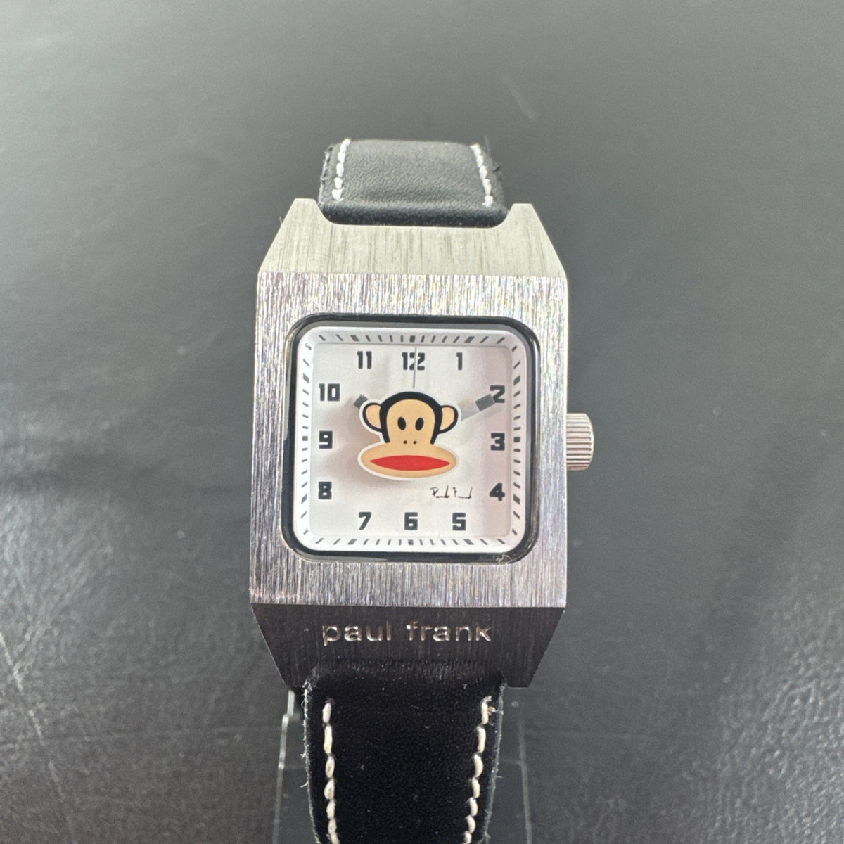 Paul Frank Julius square watch with black dial, stainless steel case, and black leather strap