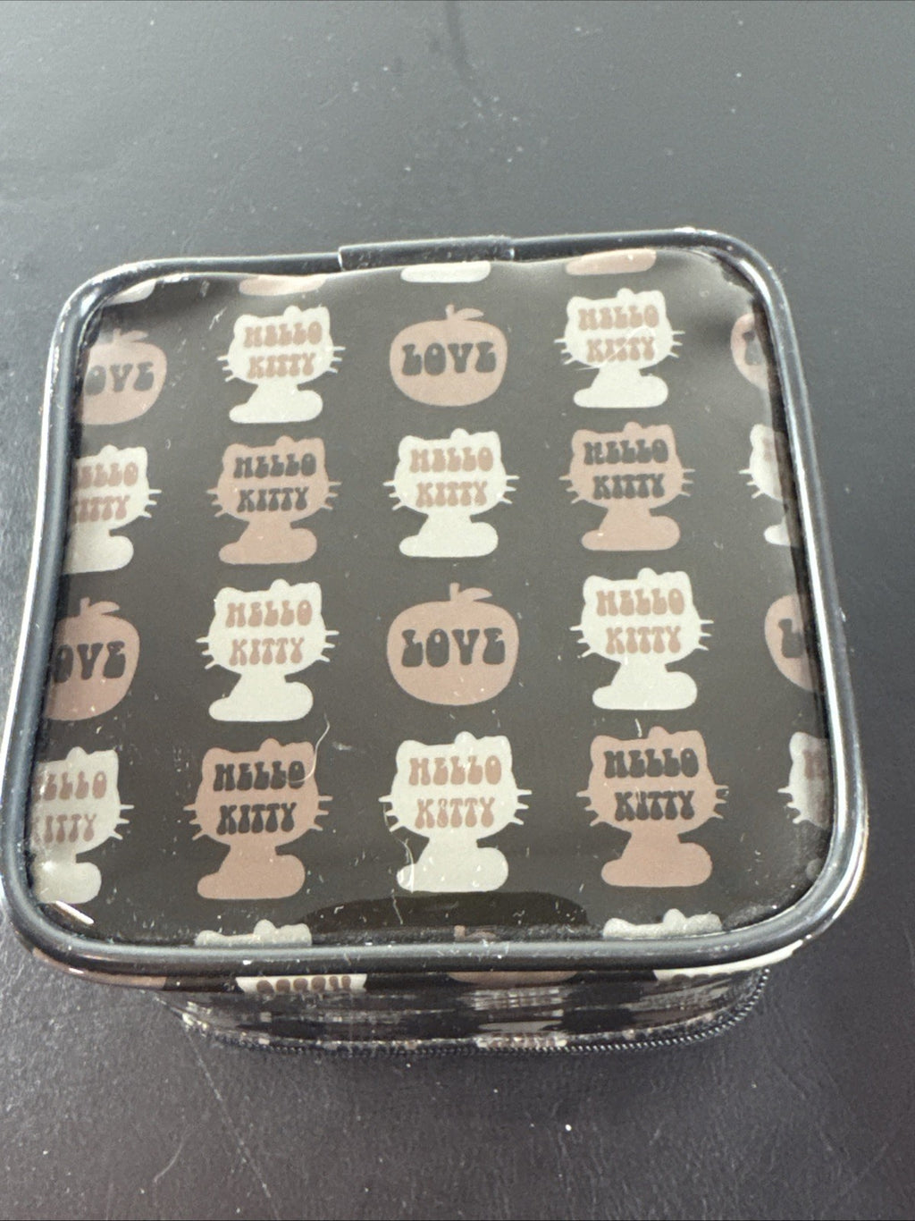 2002 Sanrio Hello Kitty watch with black and white checkerboard face, original zippered case, and tags.