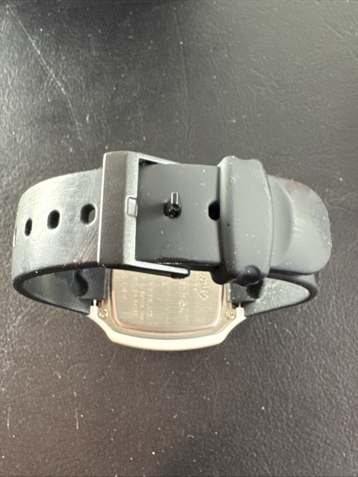 2002 Sanrio Hello Kitty watch with black and white checkerboard face, original zippered case, and tags.
