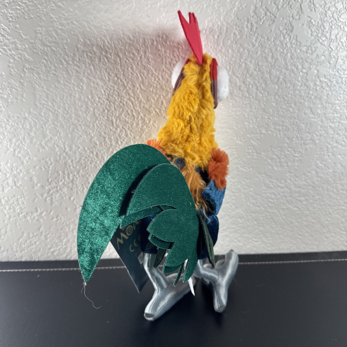 Disney Store Moana 12-inch Hei Hei rooster plush toy with original tags attached.