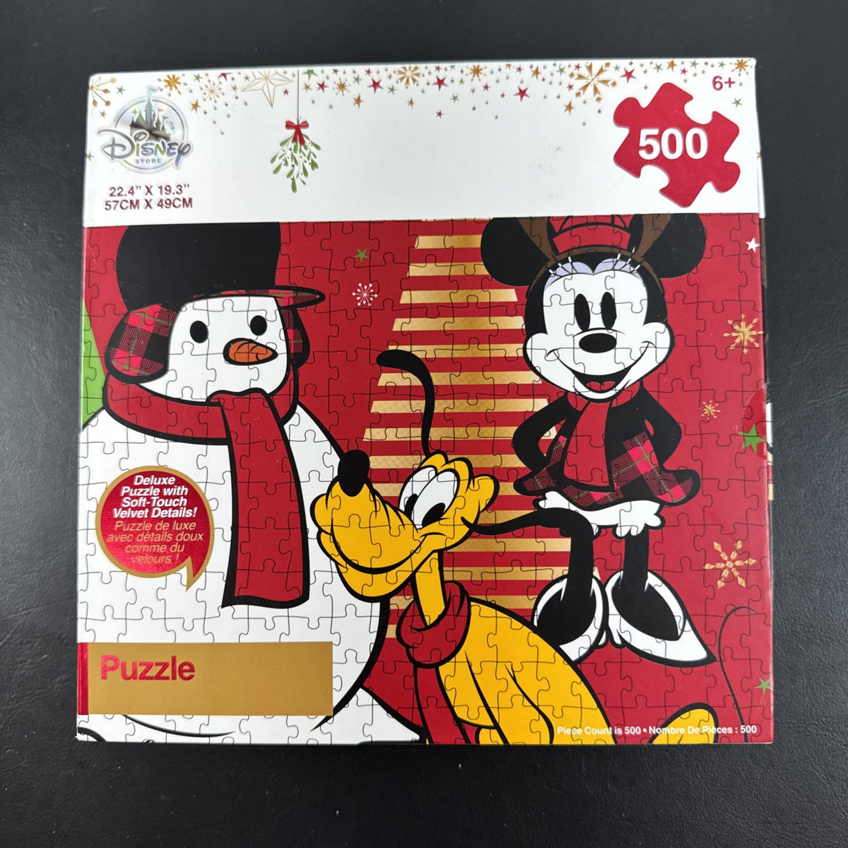 New Disney Store 500-piece Christmas jigsaw puzzle featuring Mickey Mouse, Minnie Mouse, Pluto, and a snowman.