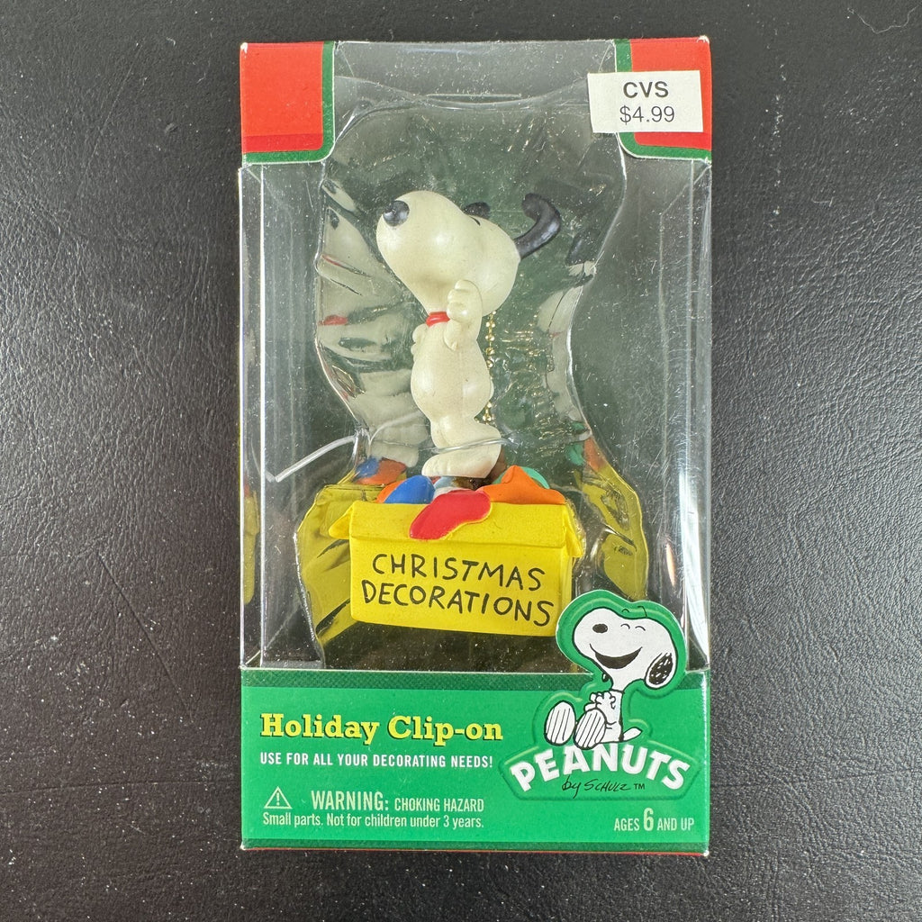 Forever Fun Peanuts Snoopy clip-on holiday ornament holding a Christmas decorations box in original packaging.