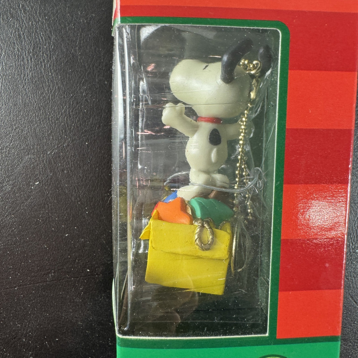 Forever Fun Peanuts Snoopy clip-on holiday ornament holding a Christmas decorations box in original packaging.