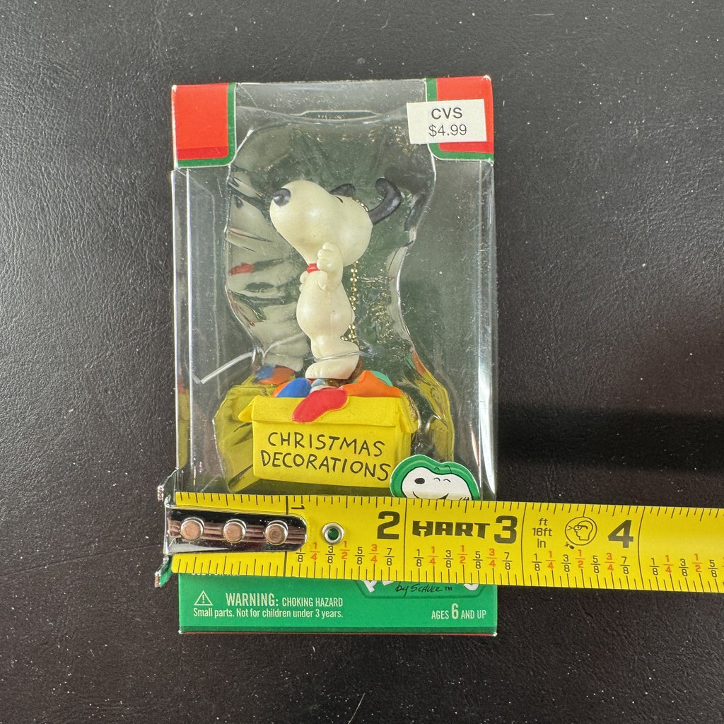 Forever Fun Peanuts Snoopy clip-on holiday ornament holding a Christmas decorations box in original packaging.