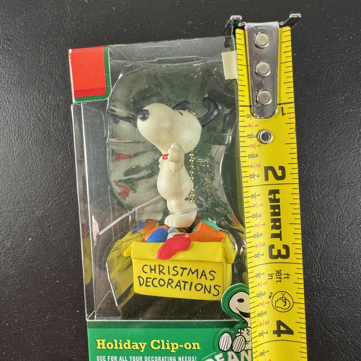 Forever Fun Peanuts Snoopy clip-on holiday ornament holding a Christmas decorations box in original packaging.