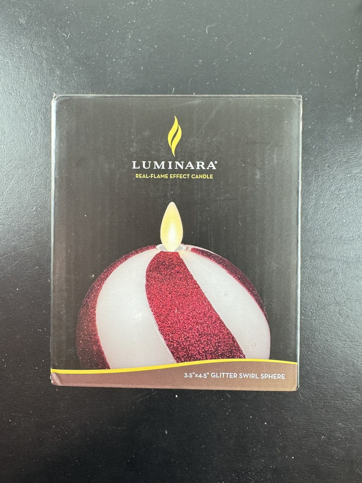 Luminara 3.5x4.5 red glitter swirl sphere real wax flameless LED candle in original packaging.