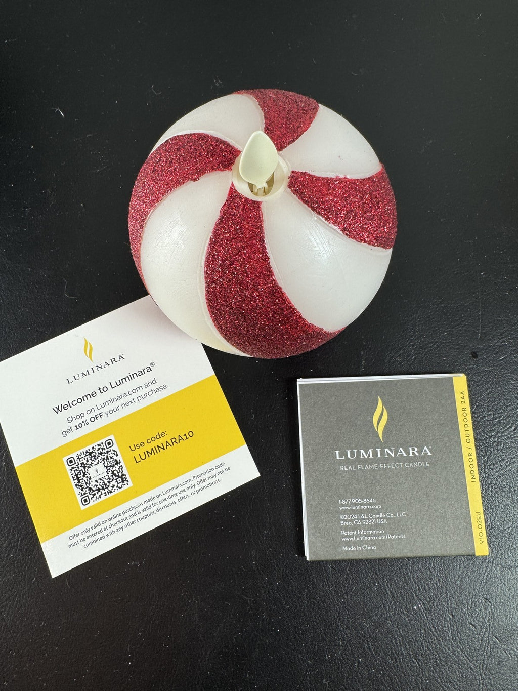 Luminara 3.5x4.5 red glitter swirl sphere real wax flameless LED candle in original packaging.