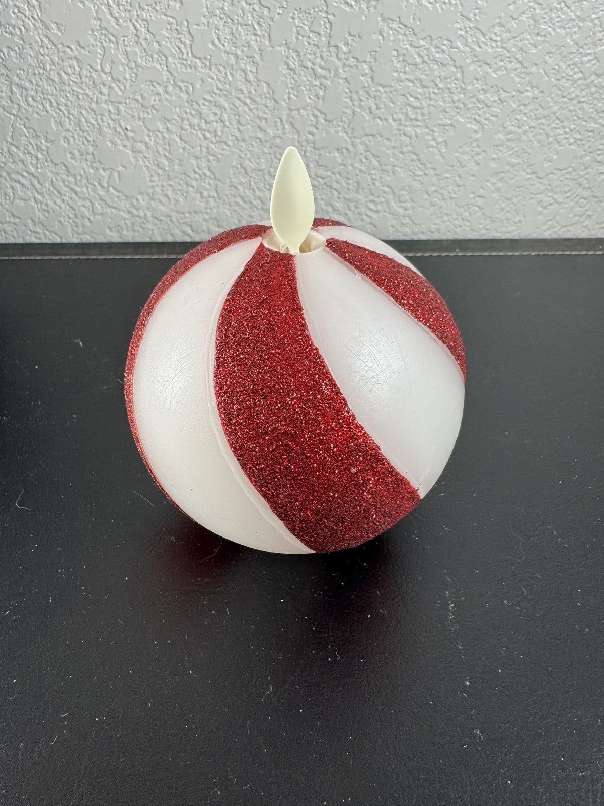 Luminara 3.5x4.5 red glitter swirl sphere real wax flameless LED candle in original packaging.