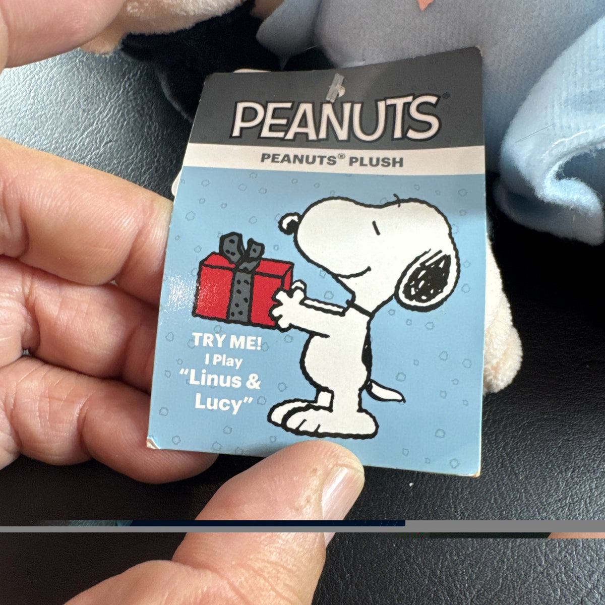 Peanuts 10-inch musical holiday plush figures set featuring Charlie Brown and Lucy in winter outfits
