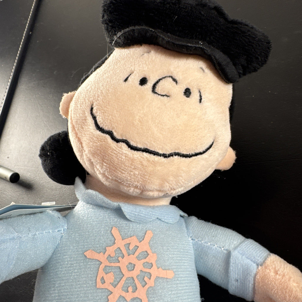 Peanuts 10-inch musical holiday plush figures set featuring Charlie Brown and Lucy in winter outfits
