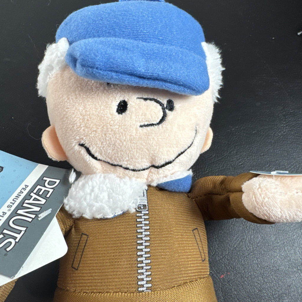 Peanuts 10-inch musical holiday plush figures set featuring Charlie Brown and Lucy in winter outfits