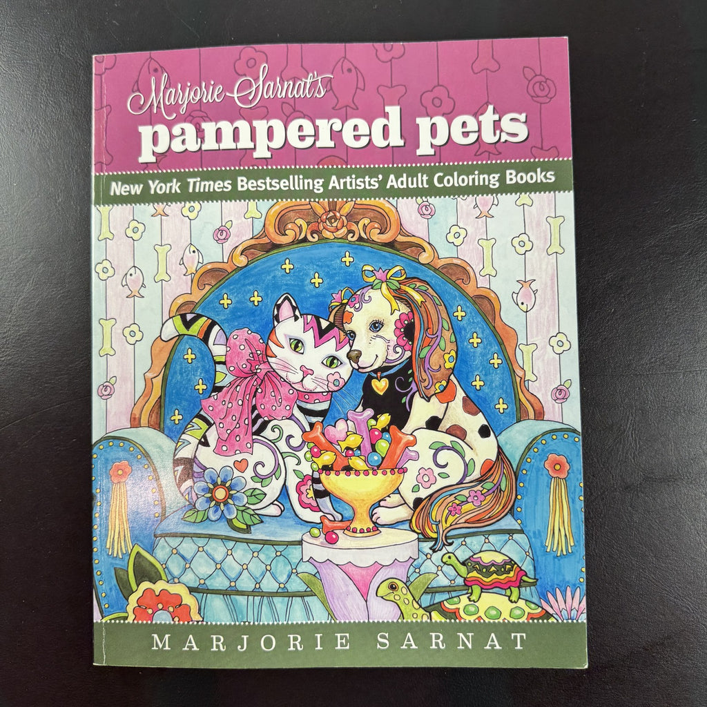 Cover of Marjorie Sarnat's Pampered Pets paperback adult coloring book featuring detailed animal illustrations.
