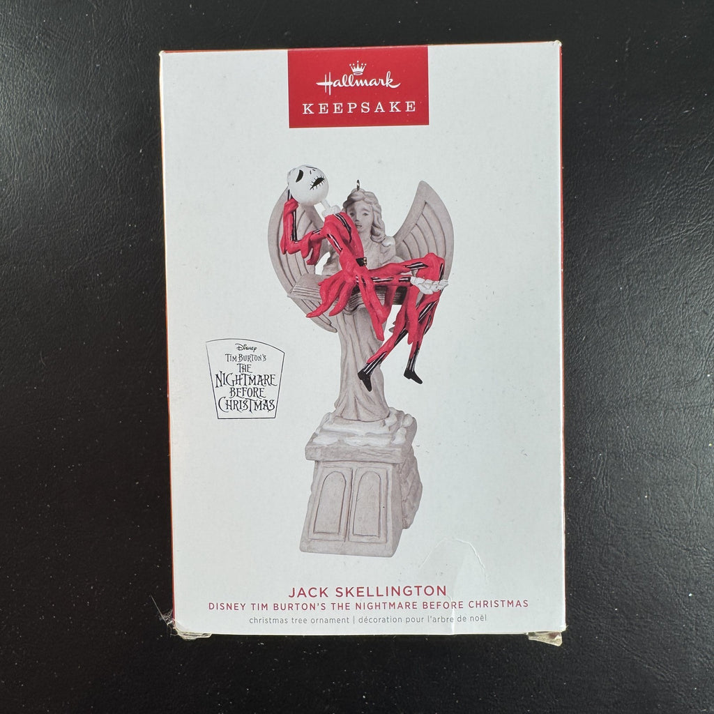 Hallmark Keepsake Jack Skellington musical Christmas ornament draped over cemetery angel