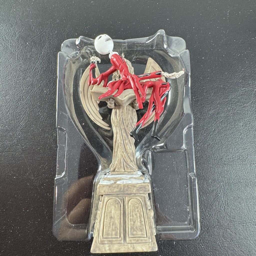 Hallmark Keepsake Jack Skellington musical Christmas ornament draped over cemetery angel
