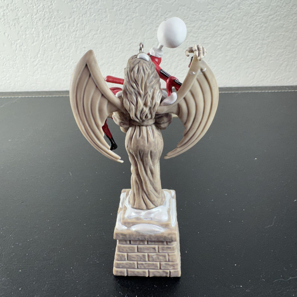 Hallmark Keepsake Jack Skellington musical Christmas ornament draped over cemetery angel
