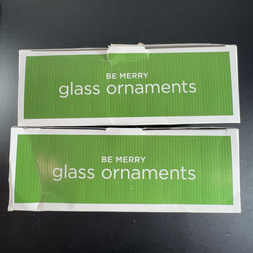 Set of 8 Target Be Merry 2008 glass snowflake Christmas ornaments in red, green, and blue original retail packaging.