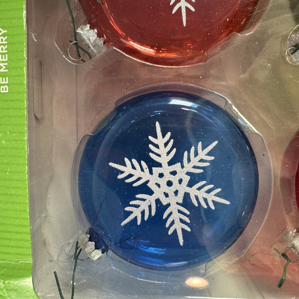 Set of 8 Target Be Merry 2008 glass snowflake Christmas ornaments in red, green, and blue original retail packaging.