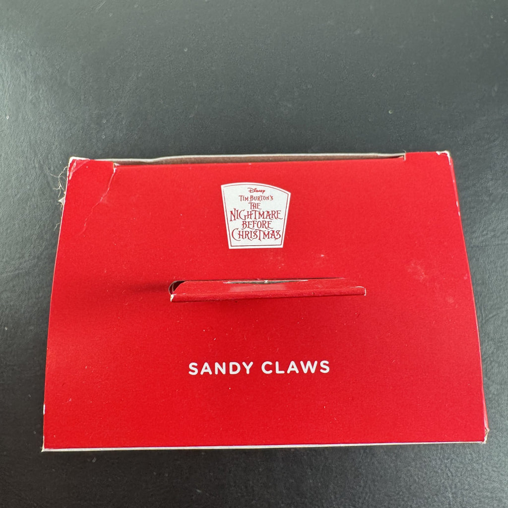 Hallmark Disney Nightmare Before Christmas Sandy Claws resin ornament in red suit holding a candy cane in original box