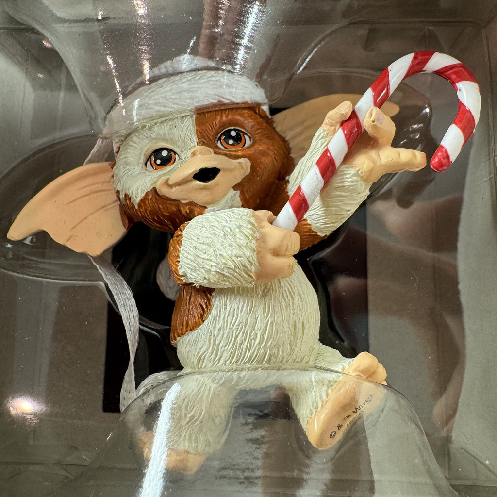 Hallmark 2024 Gremlins Gizmo resin Christmas ornament wearing a Santa hat and holding a candy cane in original packaging.