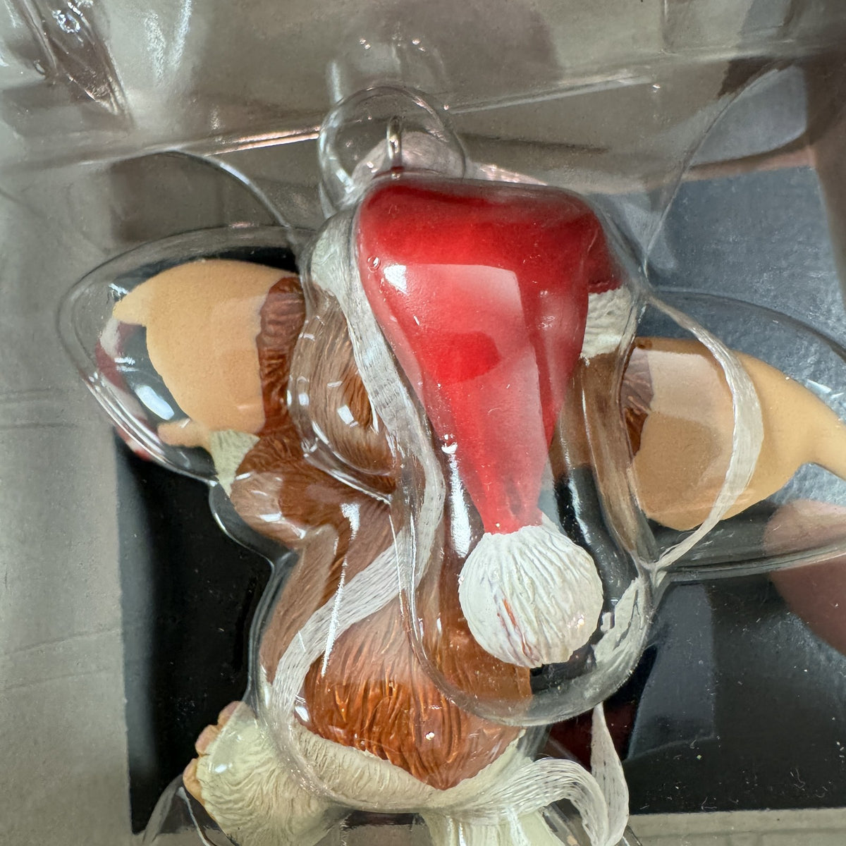 Hallmark 2024 Gremlins Gizmo resin Christmas ornament wearing a Santa hat and holding a candy cane in original packaging.