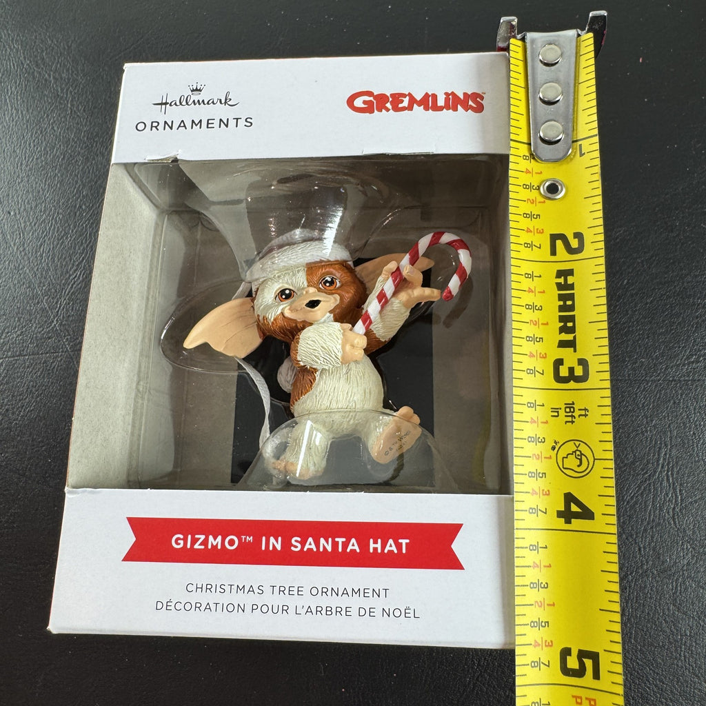 Hallmark 2024 Gremlins Gizmo resin Christmas ornament wearing a Santa hat and holding a candy cane in original packaging.