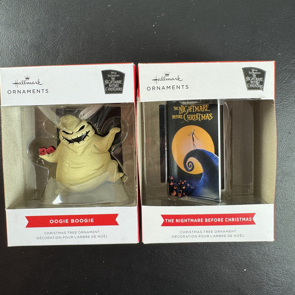 Set of two Hallmark Nightmare Before Christmas ornaments featuring Oogie Boogie holding dice and a retro VHS tape box.