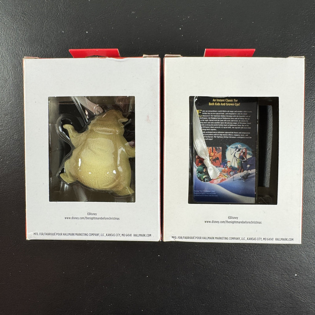 Set of two Hallmark Nightmare Before Christmas ornaments featuring Oogie Boogie holding dice and a retro VHS tape box.