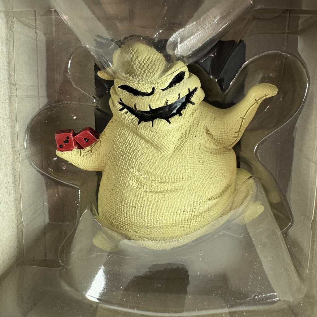 Set of two Hallmark Nightmare Before Christmas ornaments featuring Oogie Boogie holding dice and a retro VHS tape box.