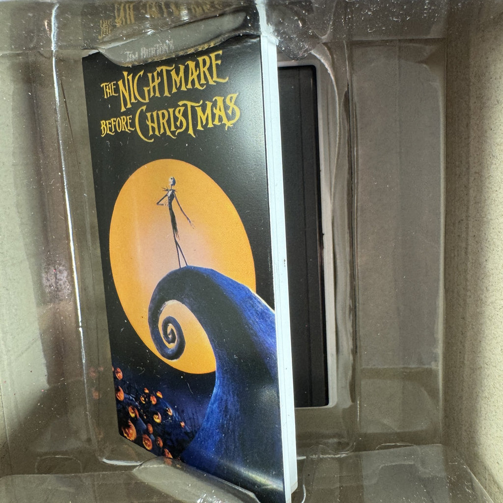 Set of two Hallmark Nightmare Before Christmas ornaments featuring Oogie Boogie holding dice and a retro VHS tape box.