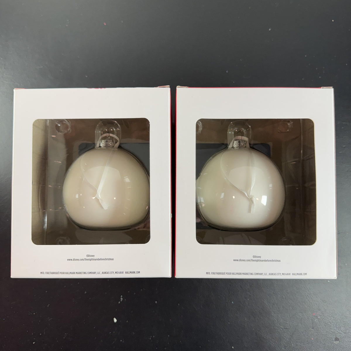 Set of two Hallmark Jack Skellington white blown glass Christmas ornaments in original packaging.