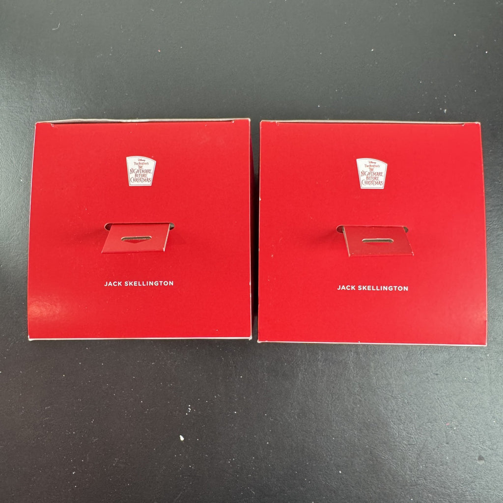 Set of two Hallmark Jack Skellington white blown glass Christmas ornaments in original packaging.
