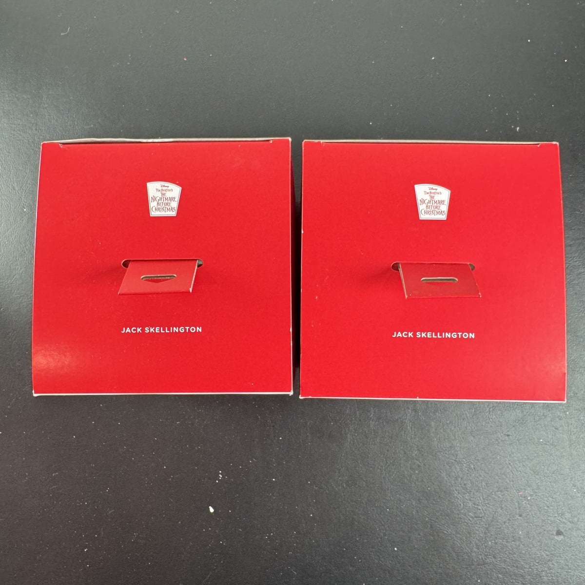 Set of two Hallmark Jack Skellington white blown glass Christmas ornaments in original packaging.