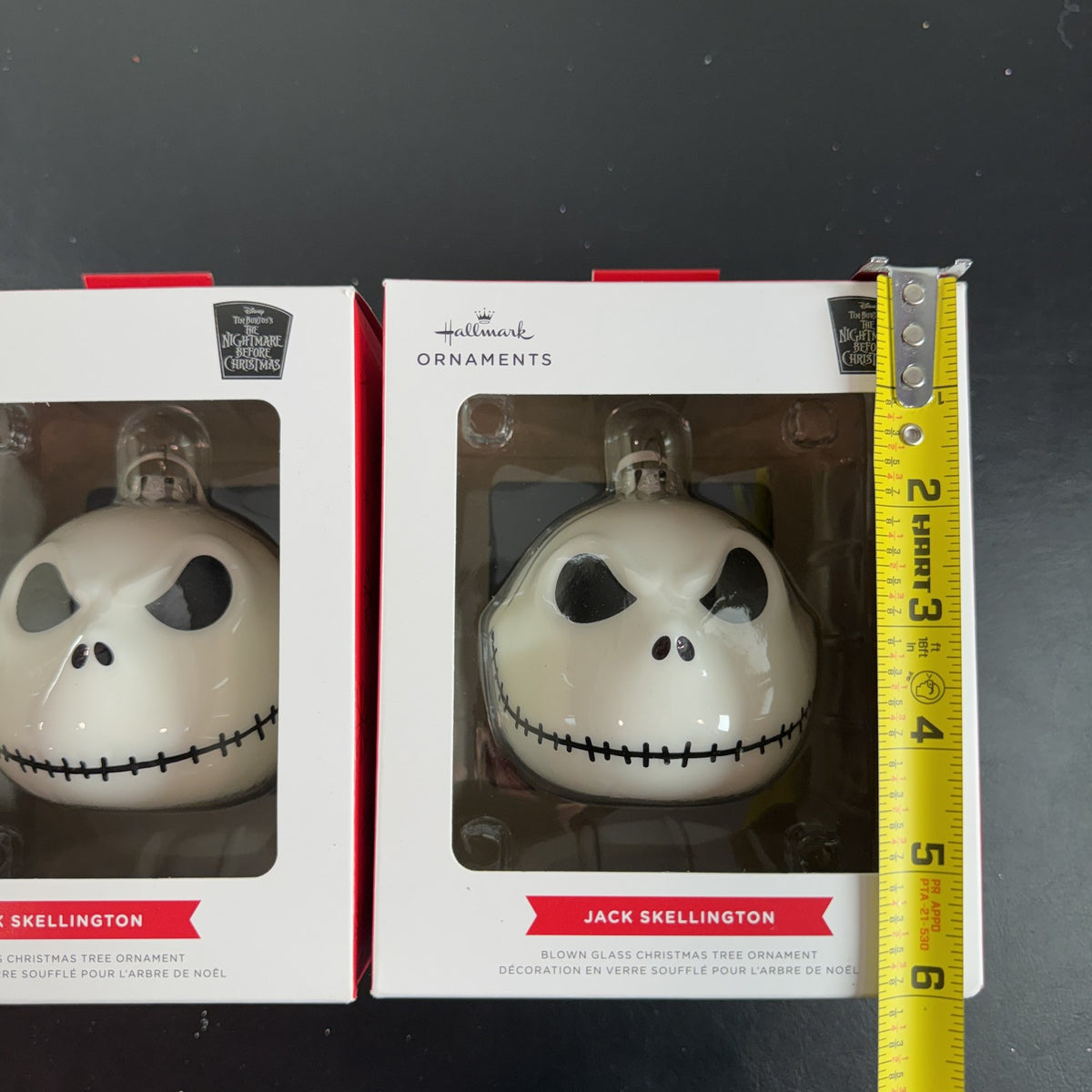 Set of two Hallmark Jack Skellington white blown glass Christmas ornaments in original packaging.